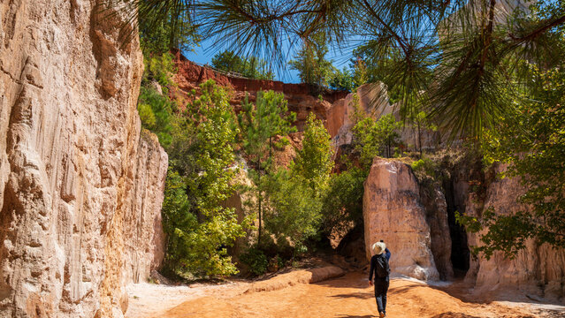 A man is enjoying the spectacular view of Providence Cayon Park, a manmade canyon, mimic of the Grand Canyon. It spans approximately 1,003 acres and features dramatic canyons with vibrant colors creat