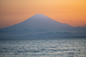 sunset over the sea with mount Fuji in the background
