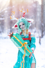 Obraz premium Christmas deer girl looking for gifts for Santa in winter in the forest
