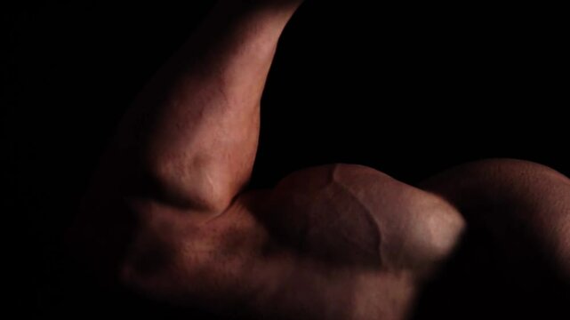 Athletic Bodybuilder Man Show His Arms Torso and Abdominal Muscles. Fitness man showing muscle. Handsome strong athletic men pumping up back muscles workout fitness and bodybuilding concept. 