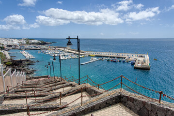 Fototapeta premium A view of Puerto Del Carmen harbour from the famous steps