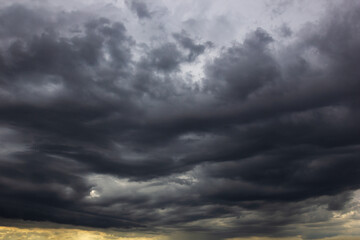 The dark sky with heavy clouds converging and a violent storm before the rain.Bad or moody weather...