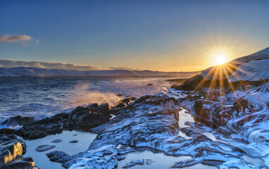 Bright dawn on the coast of the Barents Sea in the village of Teriberka in the Murmansk region of Russia.