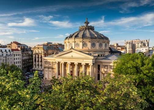 Romanian Atheneum in Bucharest during a summer sunset. Aerial view of this amazing landmark historical building from Bucharest, Romania, on Victoriei Avenue (Calea Victoriei). Travel to Romania.