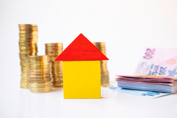 Home loan concept with pile of coins and banknotes