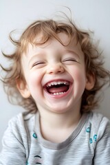 A candid portrait of a child laughing, white background, capturing pure joy