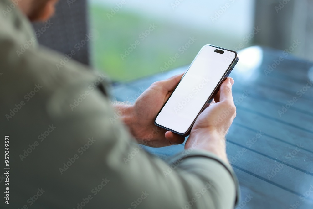 Poster Man with paper cup using smartphone at outdoor cafe, closeup. Space for design