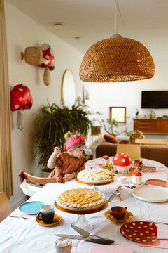 Girl looking at birthday cake at home