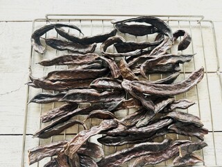 Carob beans ready to roast in the oven.
