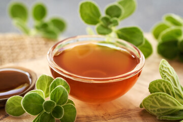 Plectranthus amboinicus syrup for common cold in a glass bowl