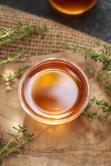 A bowl of thyme syrup on a table