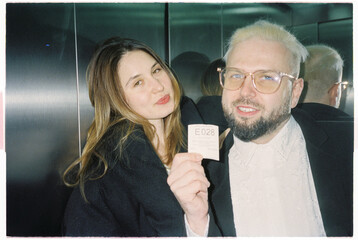 Couple posing for camera with ticket in hand