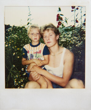 Two Brothers Sitting in a Flower Garden