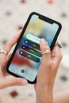 Woman Setting Phone to Do Not Disturb Mode for Uninterrupted Focus