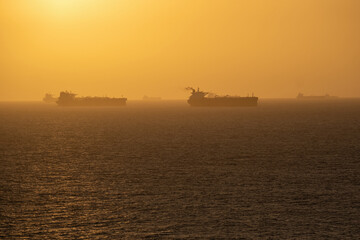 Several oil tankers waiting to enter a Venezuelan port at sunset