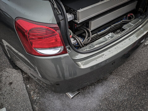 Sedan car with open trunk. In the trunk there are amplifiers for speakers, sound. For loud music and bass.