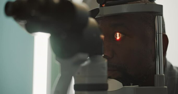 Eye care, man and machine for laser in clinic with consultation for vision, glaucoma check and retina health. Medical appointment, patient and scanning eyeball for eyesight correction and optometry