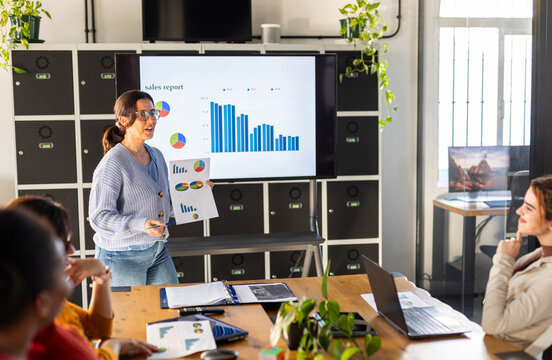WOMAN IN A COMPANY GIVING A SALES SUMMARY