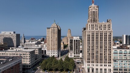 Downtown Buffalo, NY with Buffalo City Hall, office towers in morning sunshine traffic on streets below Liberty Building Art deco architecture