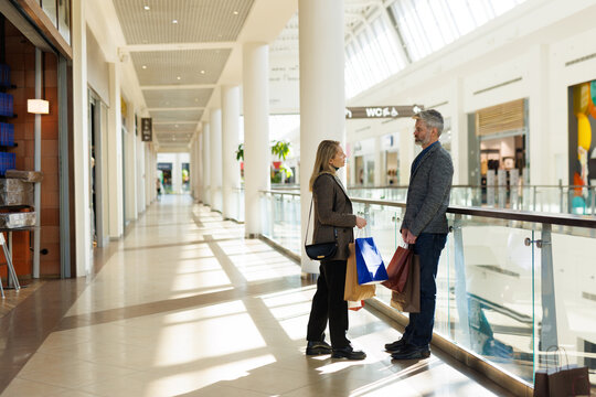 Woman telling to man at shopping mall on weekend or in free time