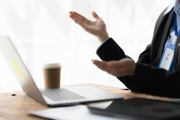 Businesswoman Presenting Ideas: A confident businesswoman gestures animatedly during a presentation, her hands conveying passion and clarity. The scene captures the energy and intensity of a compellin