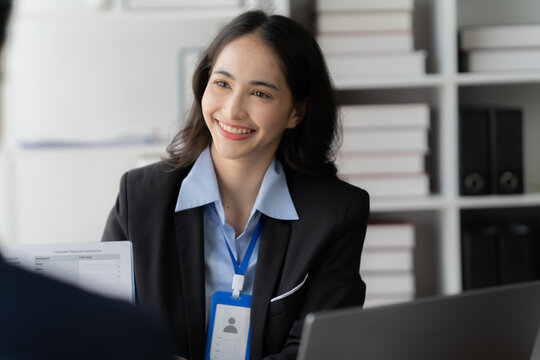 Confident Professional: A successful businesswoman smiles warmly while engaging in a professional conversation, showcasing her confidence, expertise, and approachable demeanor.  