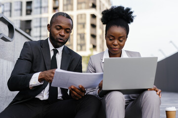 Manager dictating information from documents to assistant