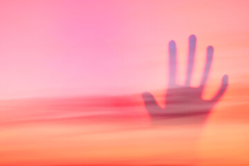 Spiritual background ghost hand on red sky