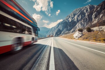 A fast-moving bus blurs as it travels on an expansive mountain road, capturing a sense of speed and adventure against a scenic backdrop.