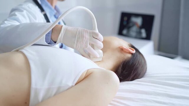 Doctor man is using ultrasound equipment on neck of female patient lying down for a medical examination. Medicine and science