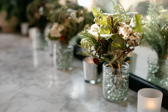 Row of Floral Bouquets and Candles as Decor at a Wedding