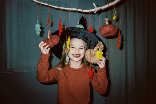 Smiling girl with halloween decorations
