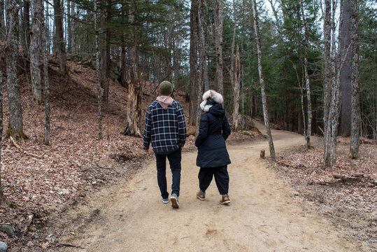 Anonymous mother and adult son hiking