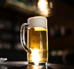 a beer mug is standing on a sled.