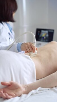 Doctor performing ultrasound examination on patient's back