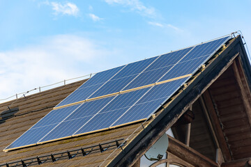 photovoltaic panels on a black roof at sunset
