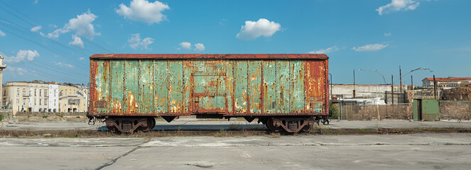 Abandoned and Weathered Cargo Train Carriage: A Rusty Relic of the Past