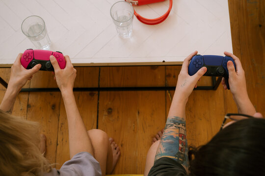 Crop unrecognizable women with gamepads