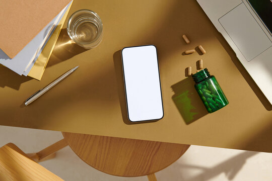 Mockup smartphone with blank screen, notebook and supplement pills