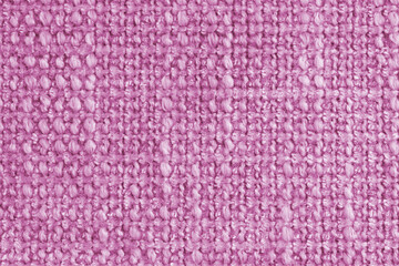Texture of pink jacquard fabric of rough weave, cloth structure background, close up, macro