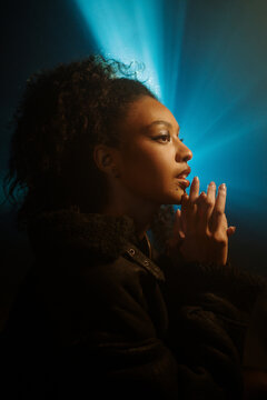 Fashion Woman With Light Rays Behind 