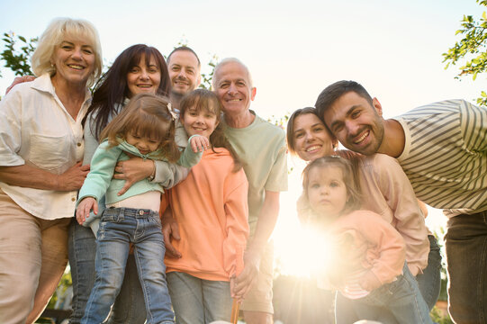 Portrait of a family of several generations in the garden  - Powered by Adobe