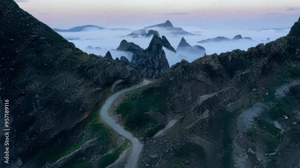 Poster winding road leads to a mysterious cave in a foggy valley surrounded by mountains. the landscape fee