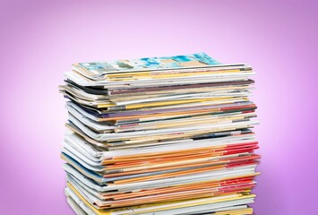 Pile of old retro paper magazines on background