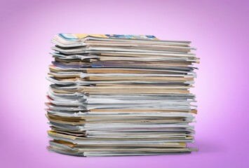 Pile of old retro paper magazines on background