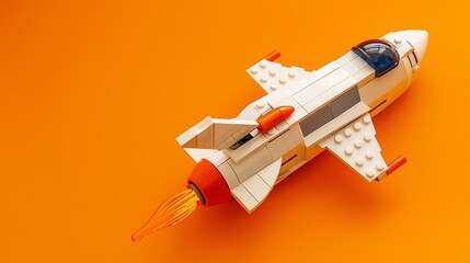 Naklejka premium Spaceship toy on orange background