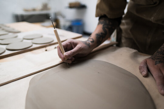 ceramist creating handmade clayware in workshop