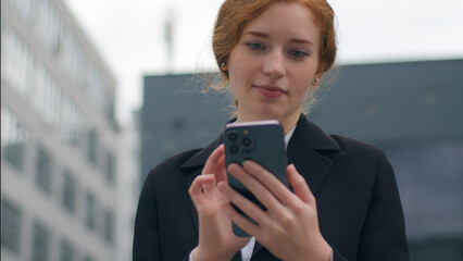 Young Caucasian girl business woman female student businesswoman using mobile phone holding...