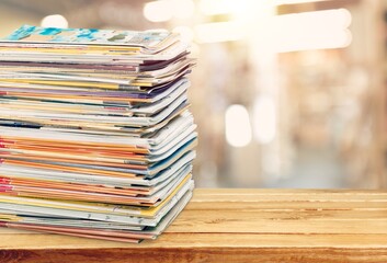 Pile of old retro paper magazines on background