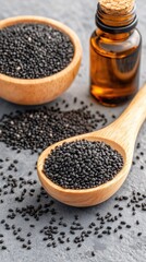 A wooden bowl of black cumin seeds stands beside glass bottles of black cumin oil on a rustic table, bathed in natural light for a serene health atmosphere